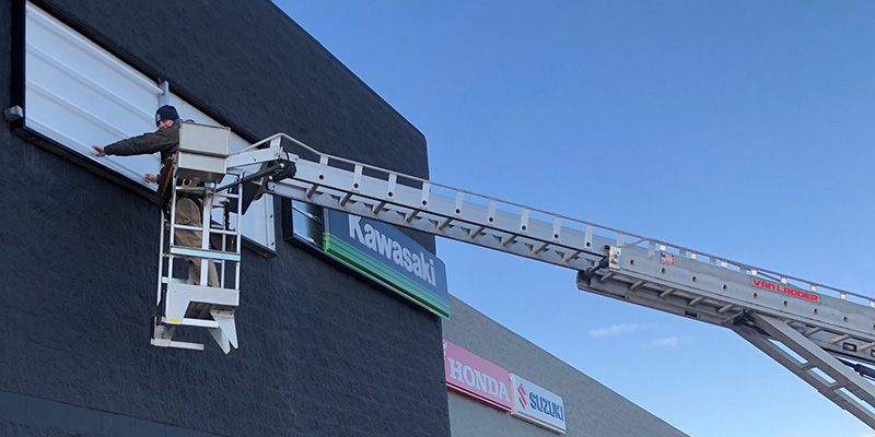 Man Working On Sign